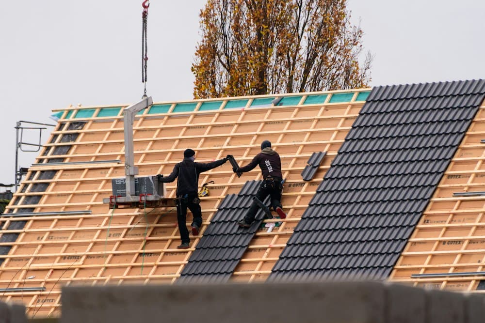 Roofing crew installing a new roof during a capital project