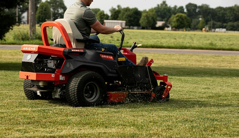 Grounds crew mowing a commercial property with a riding mower